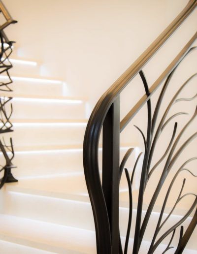 A close up of a wrought iron railing on a set of stairs