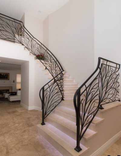 A staircase with a wrought iron railing leading up to the second floor