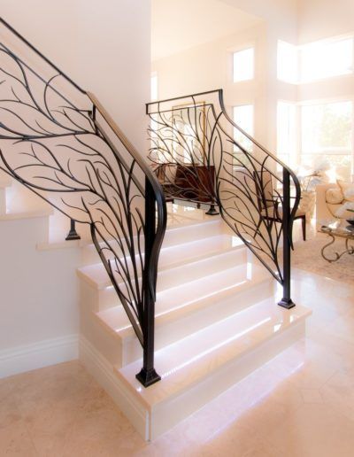 A staircase with a wrought iron railing in a living room