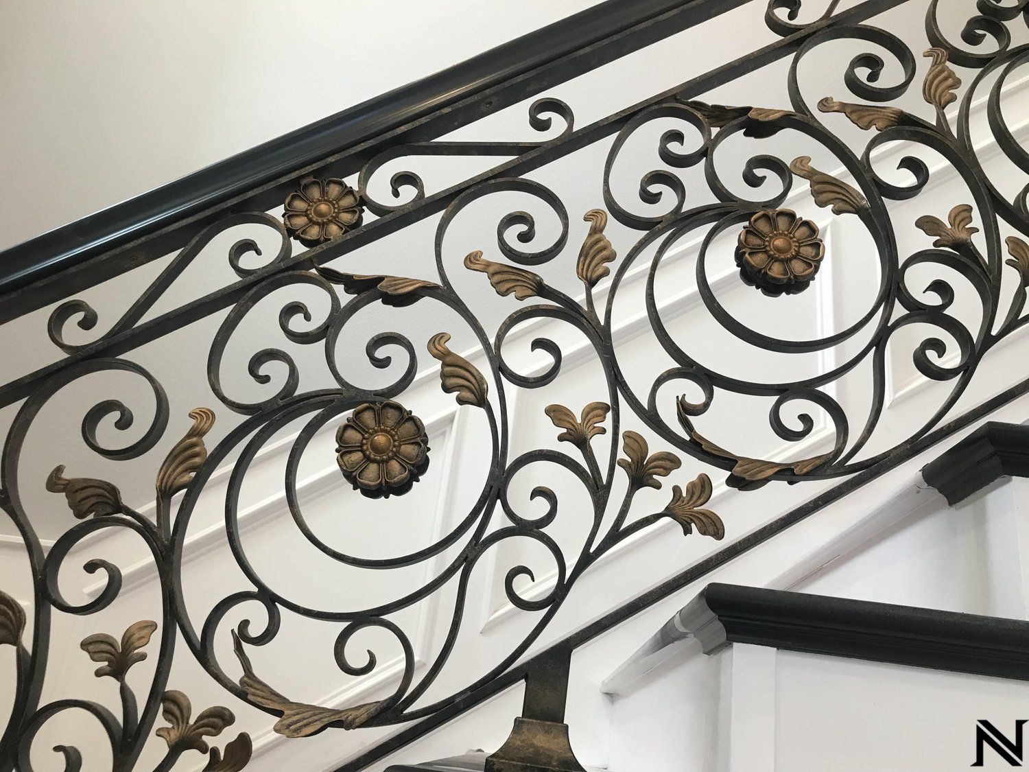 A close up of a wrought iron railing on a staircase.