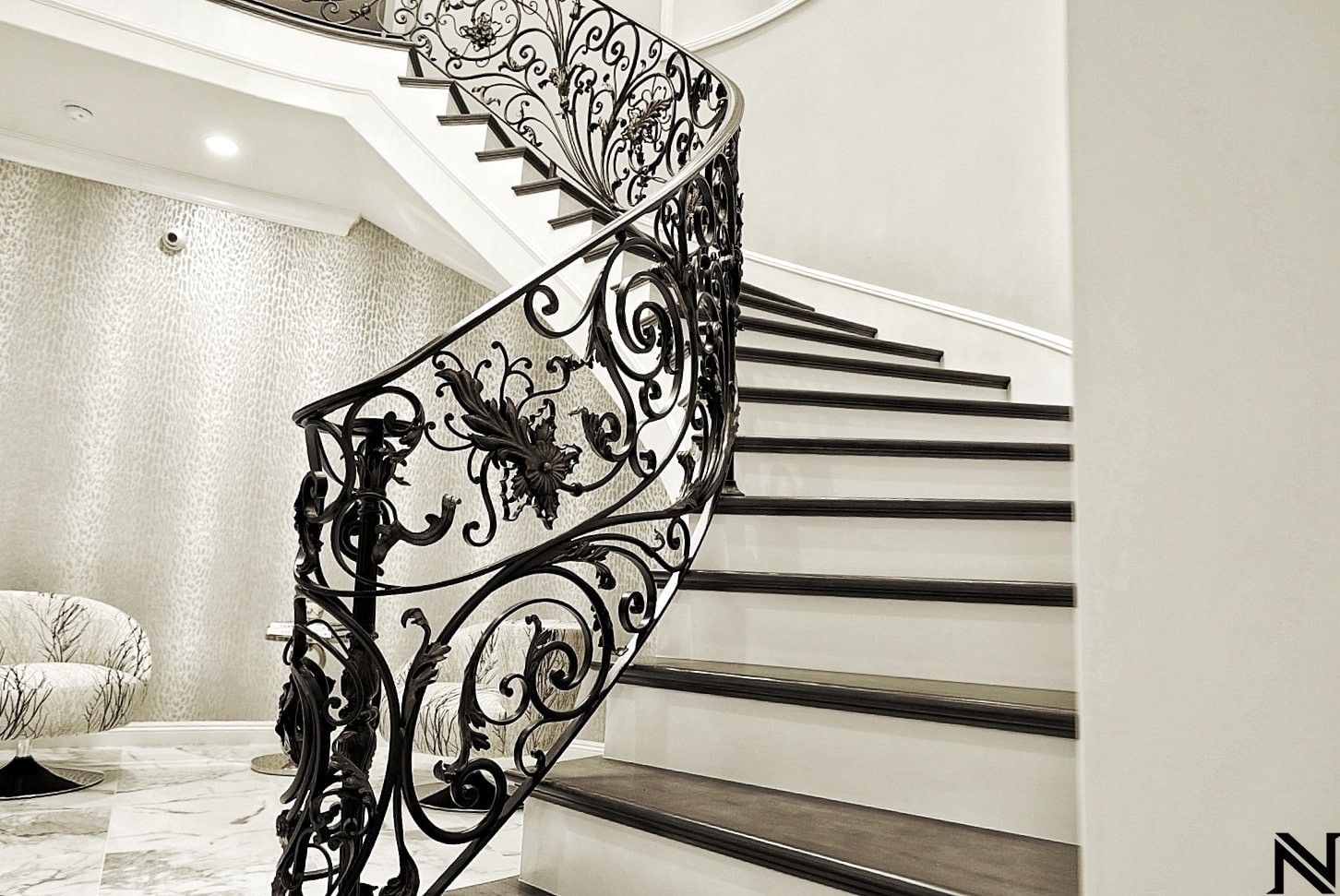 A black and white photo of a staircase with a wrought iron railing