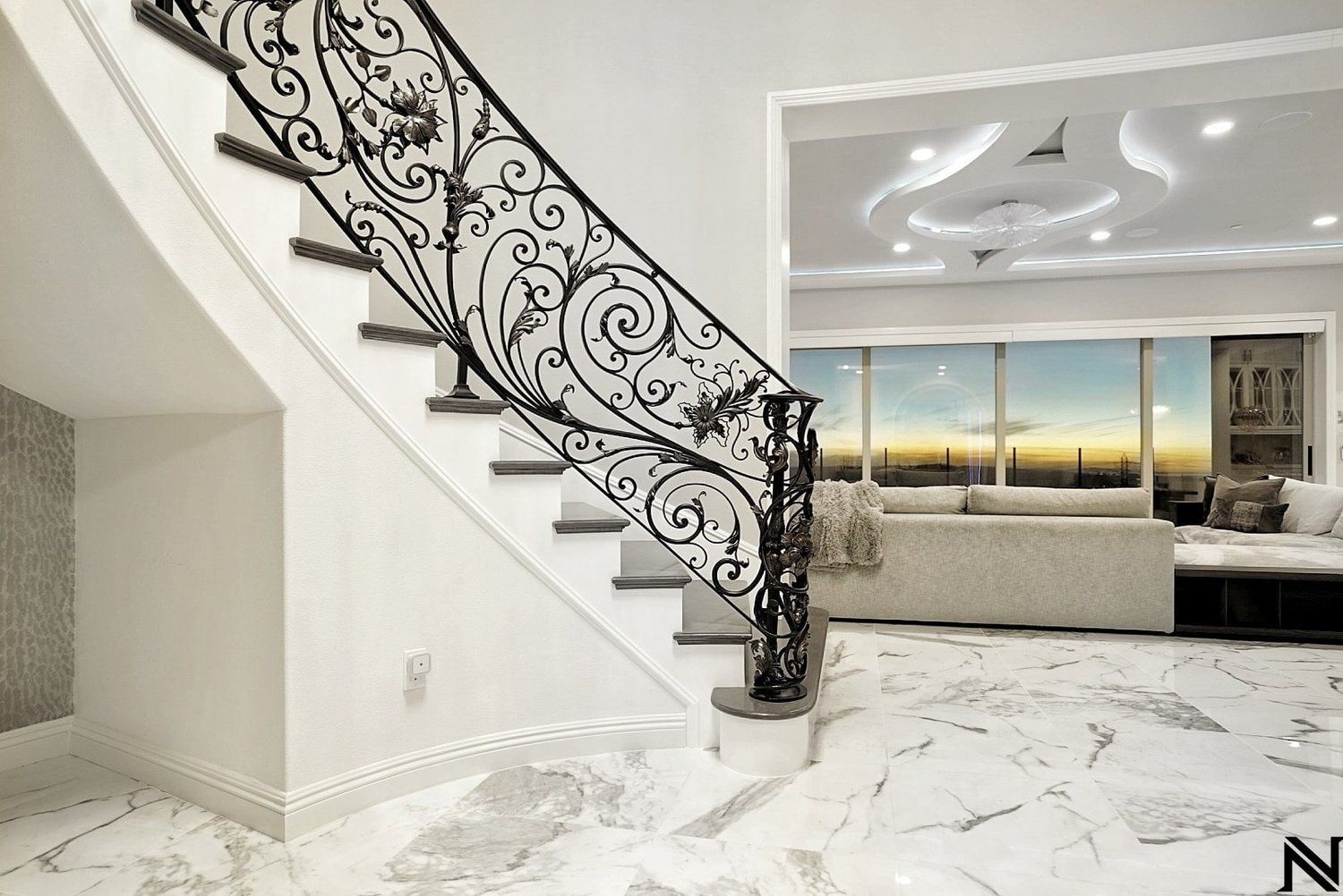 A staircase with a wrought iron railing in a living room