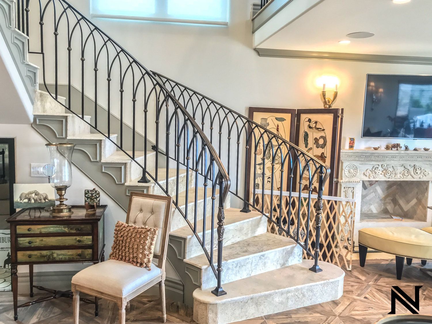 A staircase with a wrought iron railing in a living room