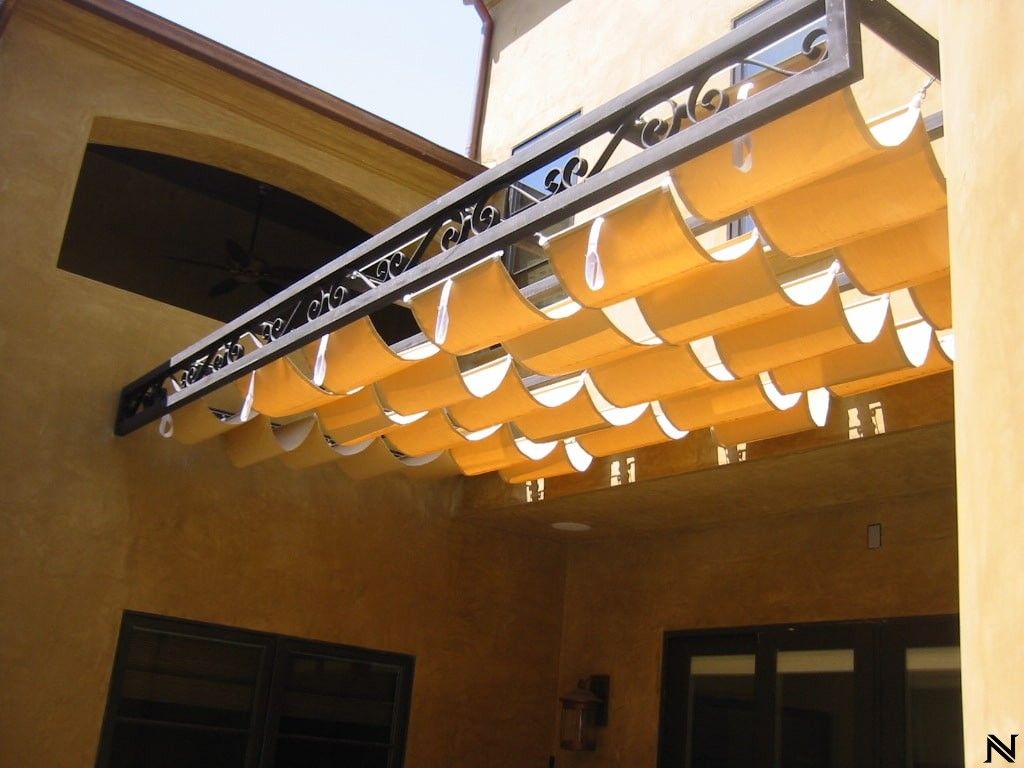 A yellow awning is hanging from the side of a building