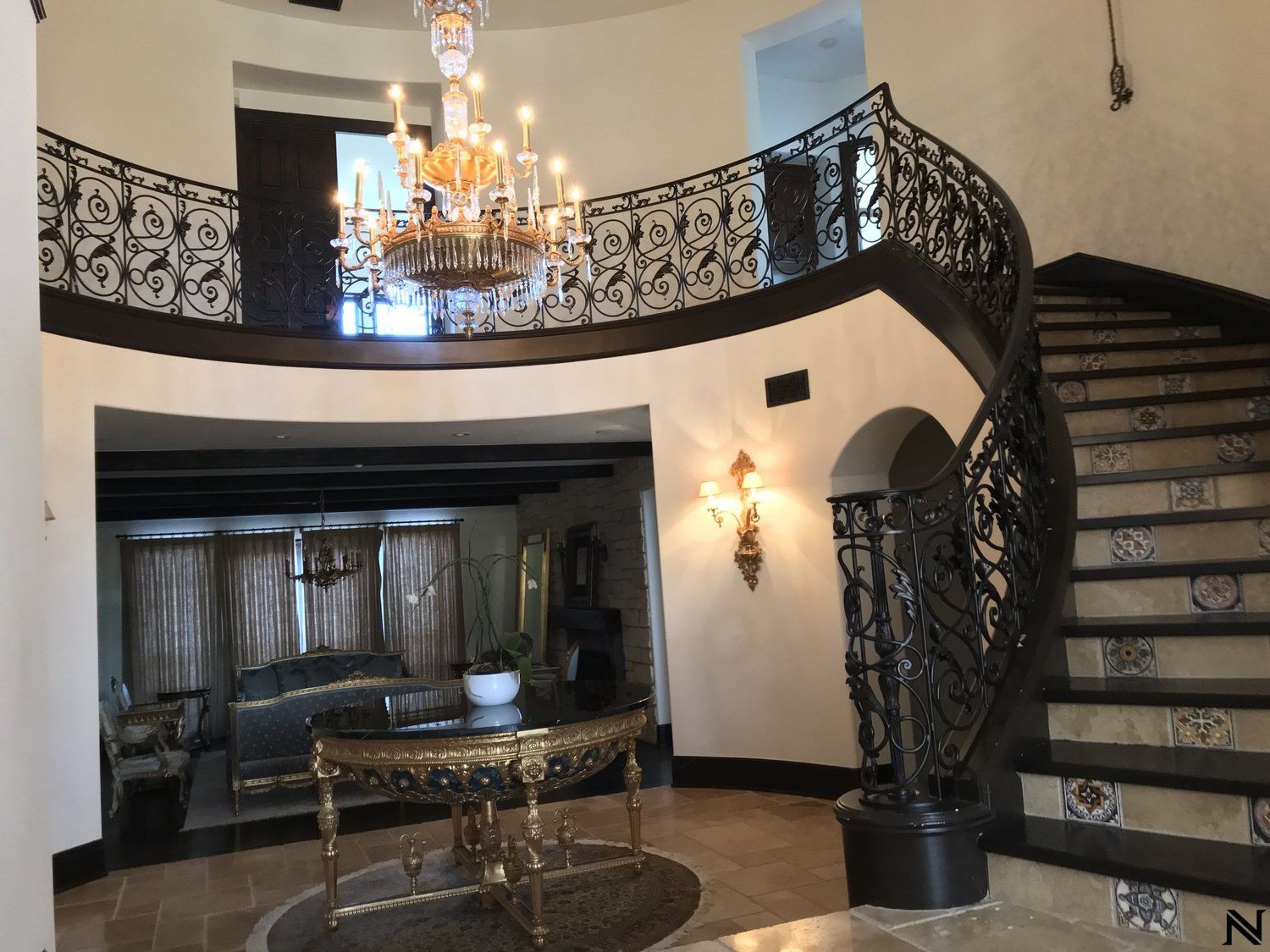 A large room with a staircase and a chandelier