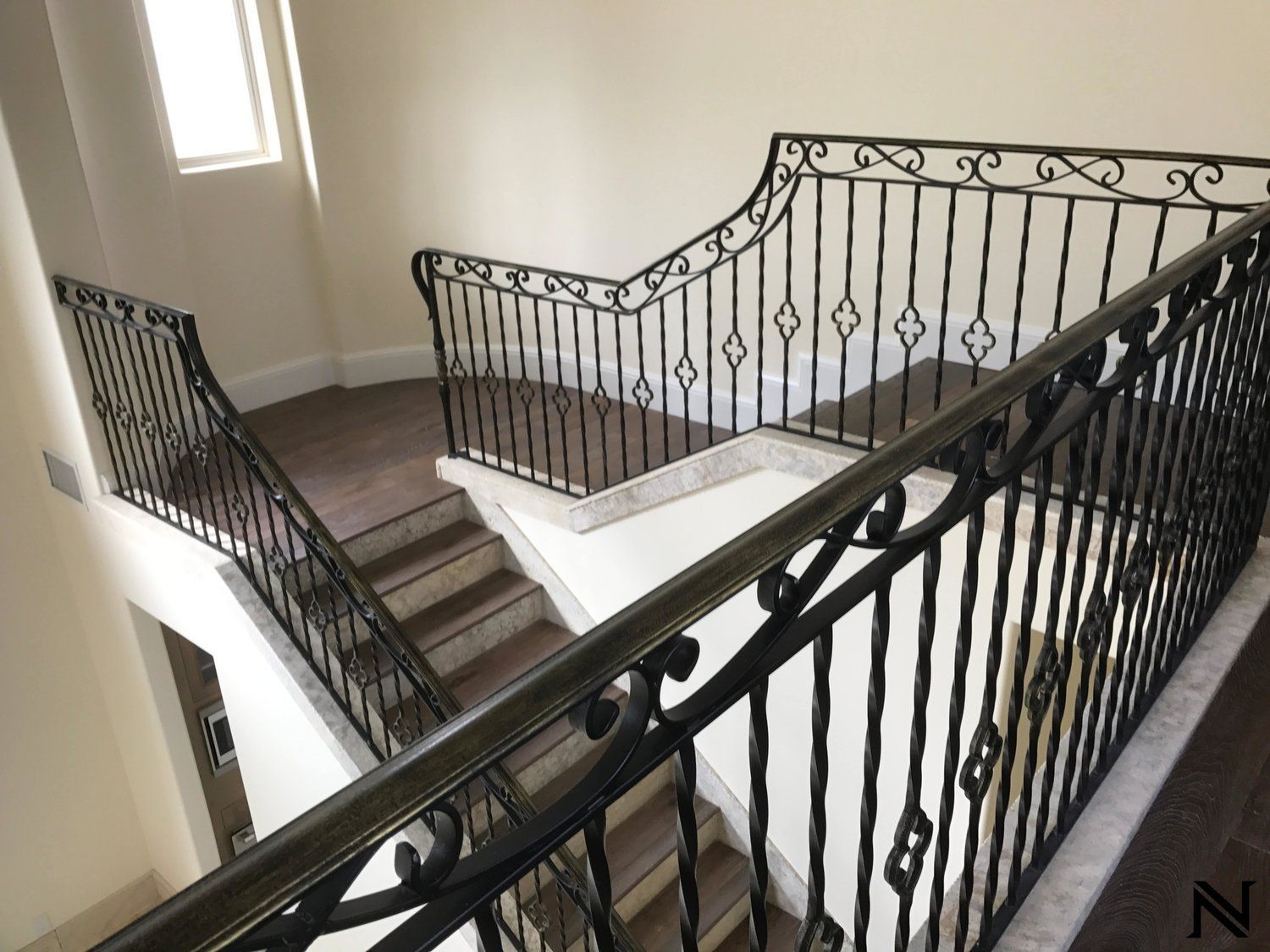 A staircase with a wrought iron railing and the letter z on the bottom