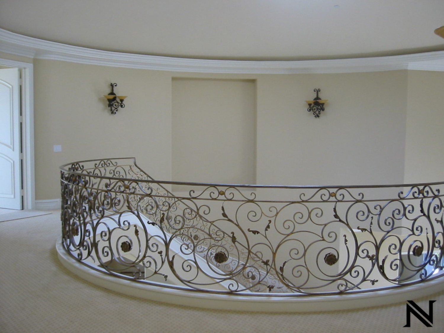 A wrought iron railing with the letter n on the bottom