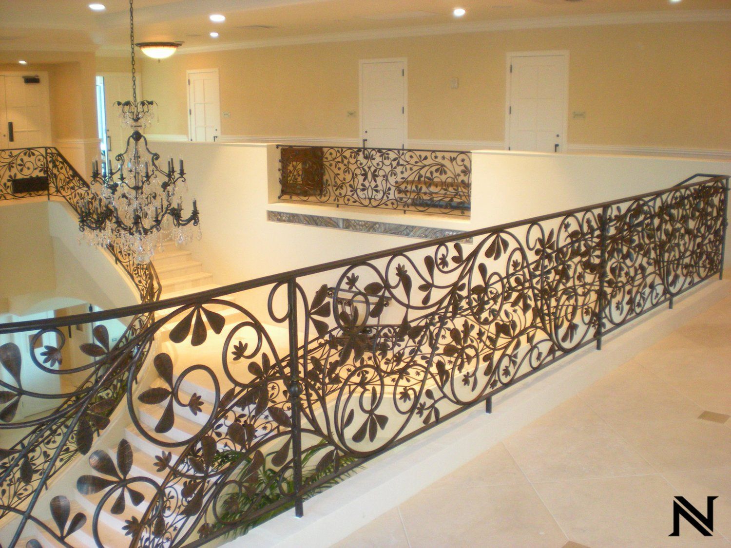A staircase with a wrought iron railing and the letter n in the corner