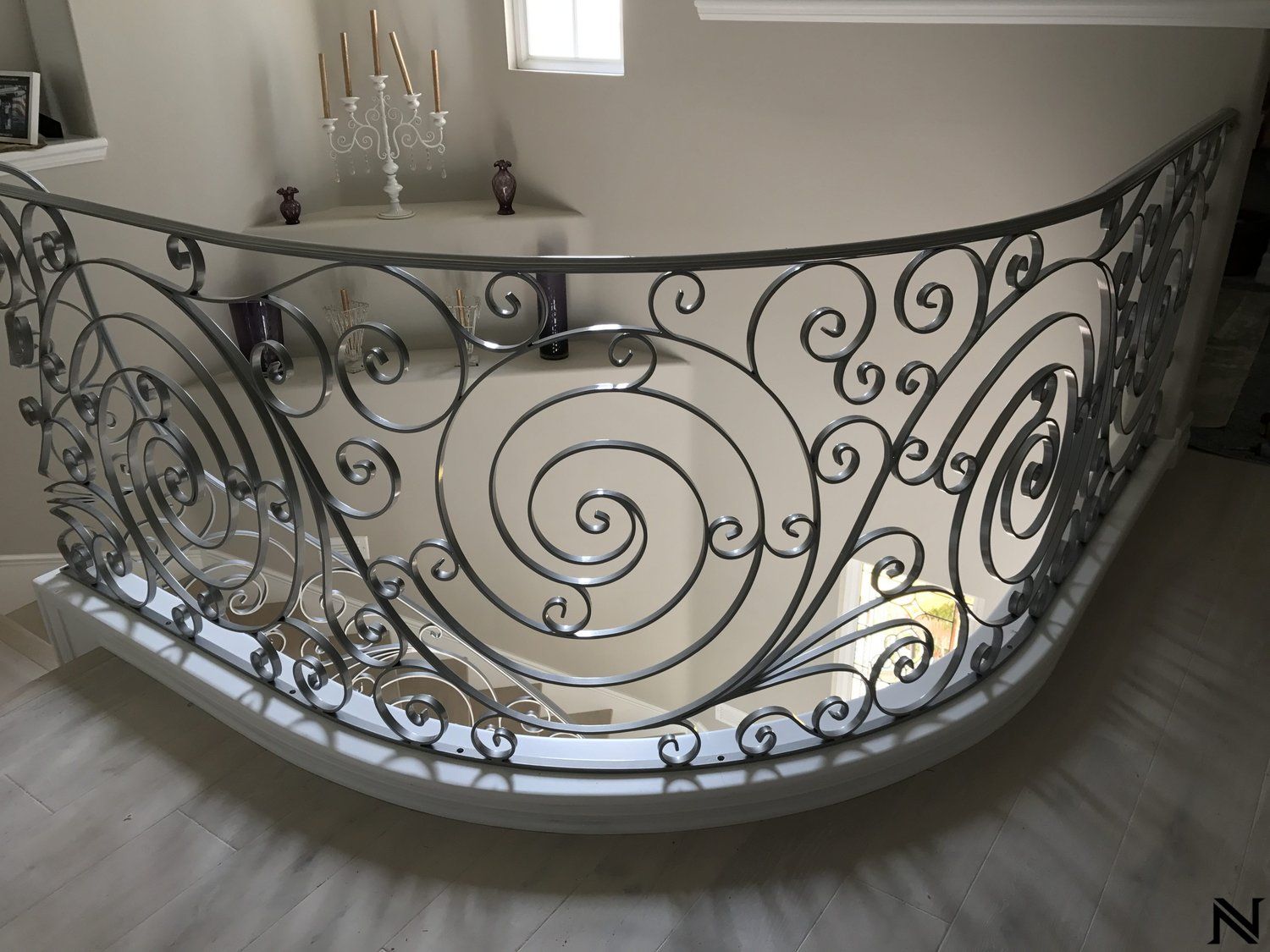 A wrought iron railing on a staircase in a house