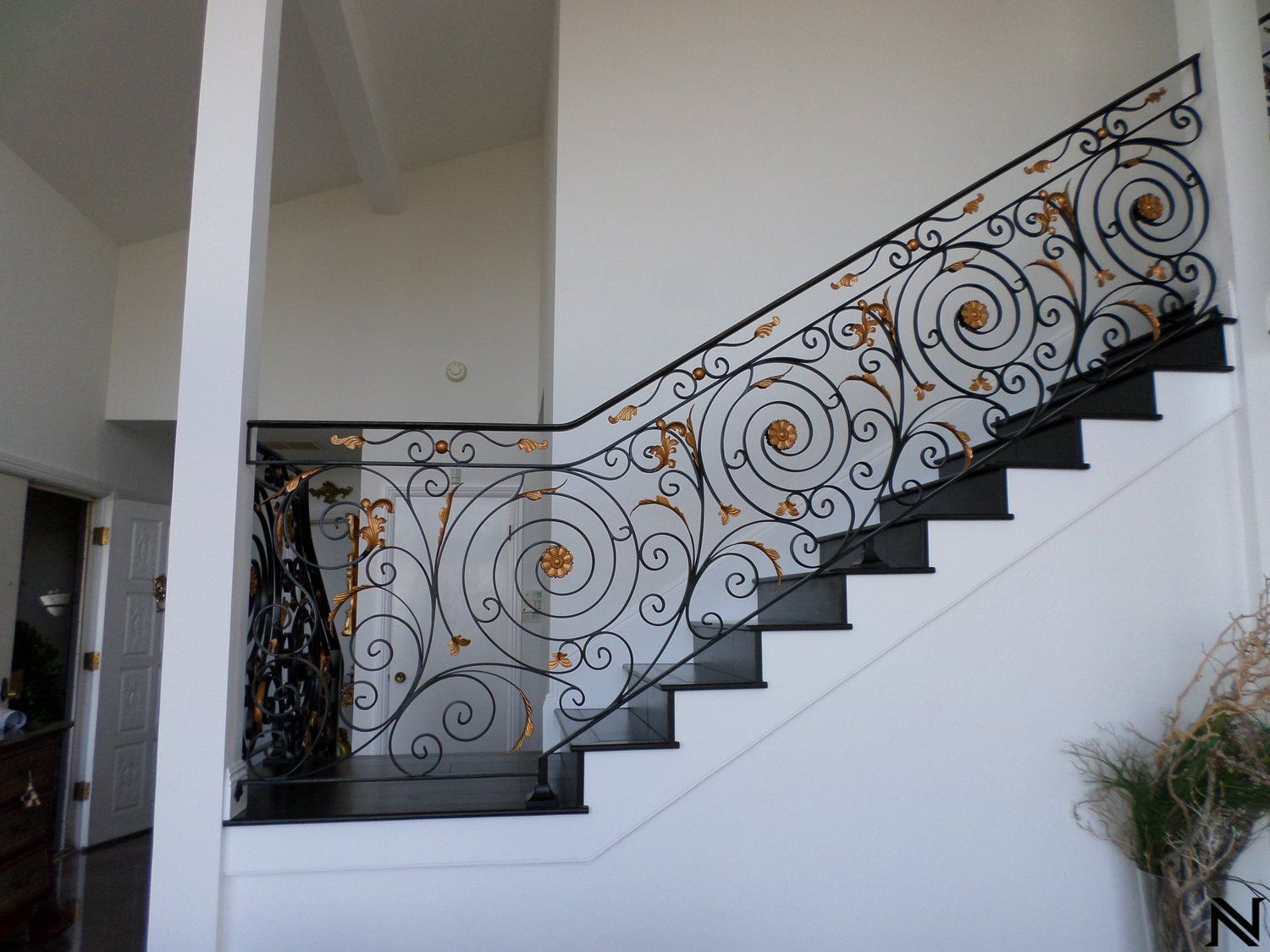 A staircase with a wrought iron railing in a house