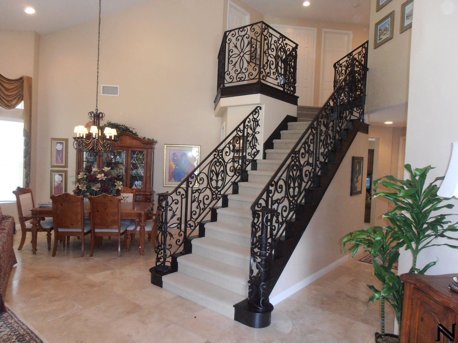 A staircase with a wrought iron railing in a house
