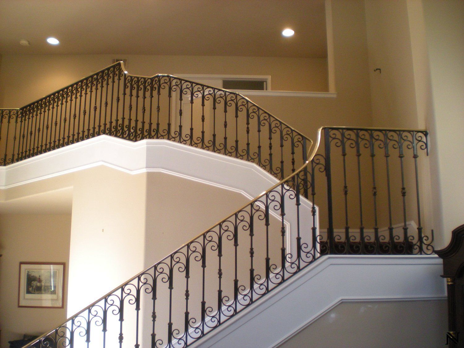 A staircase with a wrought iron railing in a house