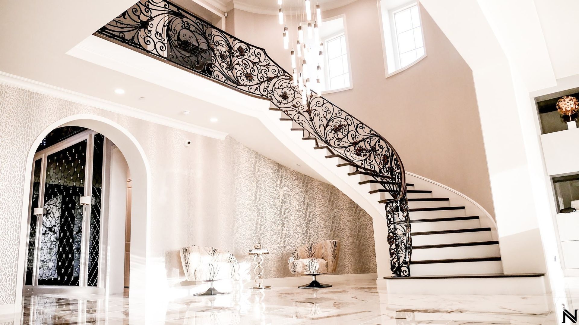 A black and white photo of a spiral staircase in a house