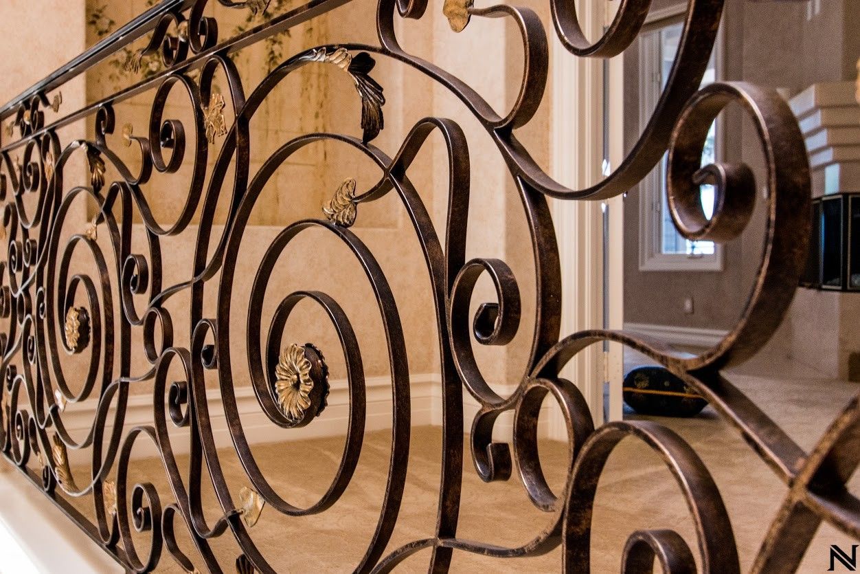 A wrought iron railing with the letter n on it