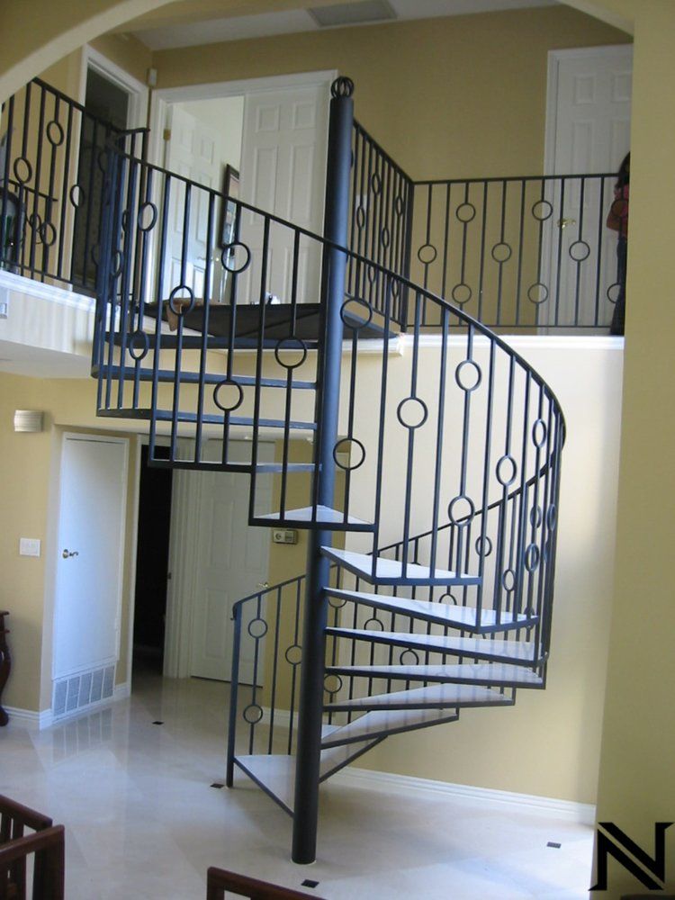 A spiral staircase with the letter n on the bottom
