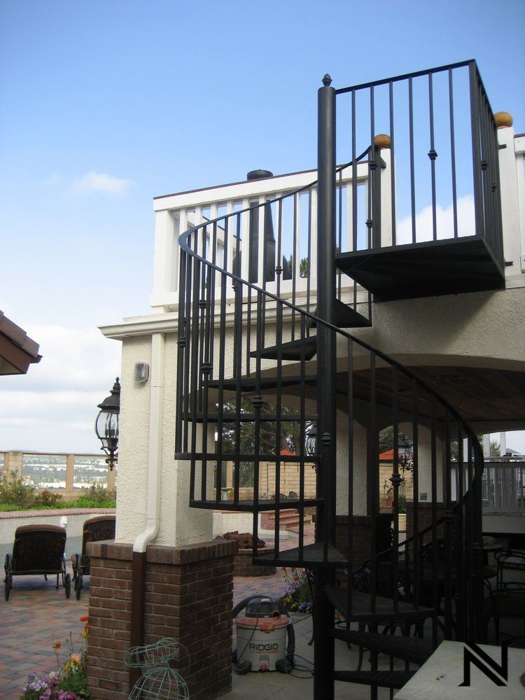 A spiral staircase on the side of a building