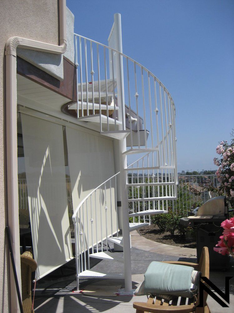 A spiral staircase leading up to the second floor of a house