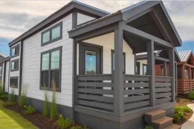 Modern gray two-story house with a covered front porch and small steps.