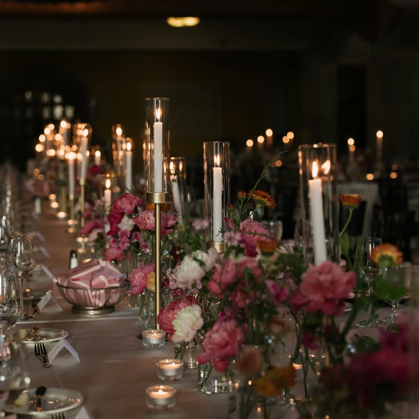 A long table with candles and flowers on it