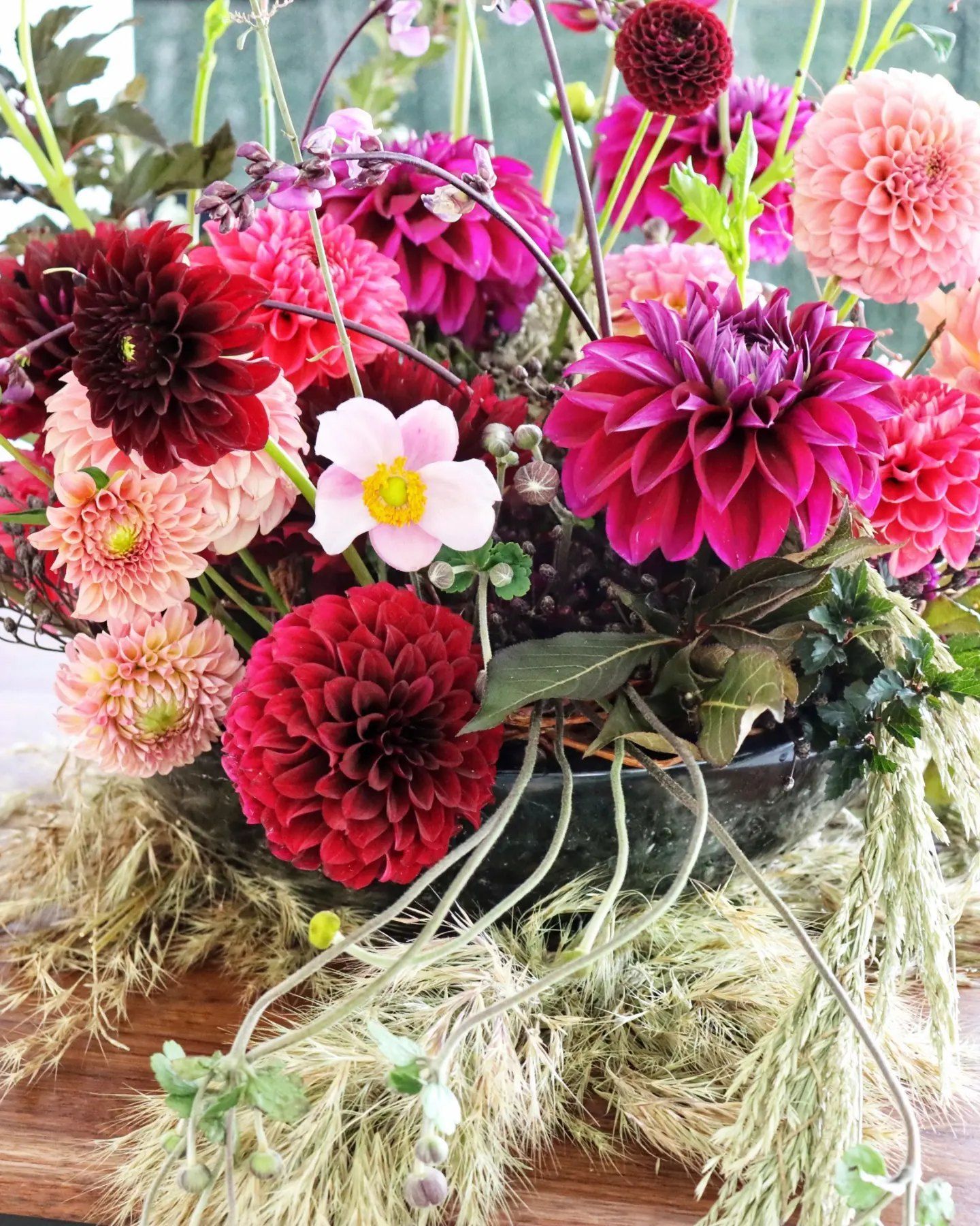 A close up of a vase filled with flowers on a table.