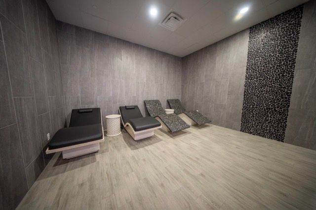 Modern relaxation room with several reclining lounge chairs and dim lighting