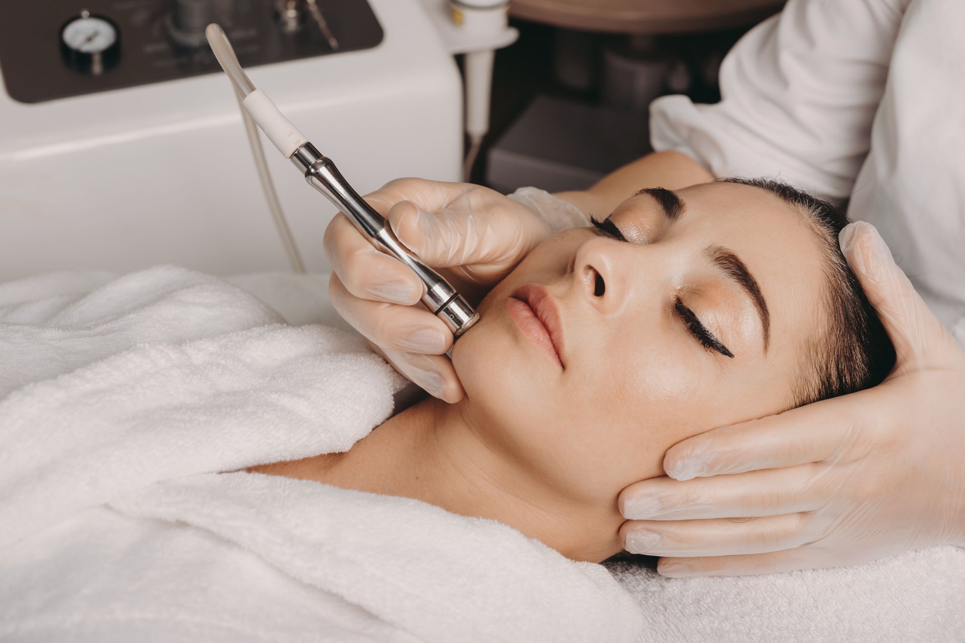 A woman is getting a facial treatment at a spa.