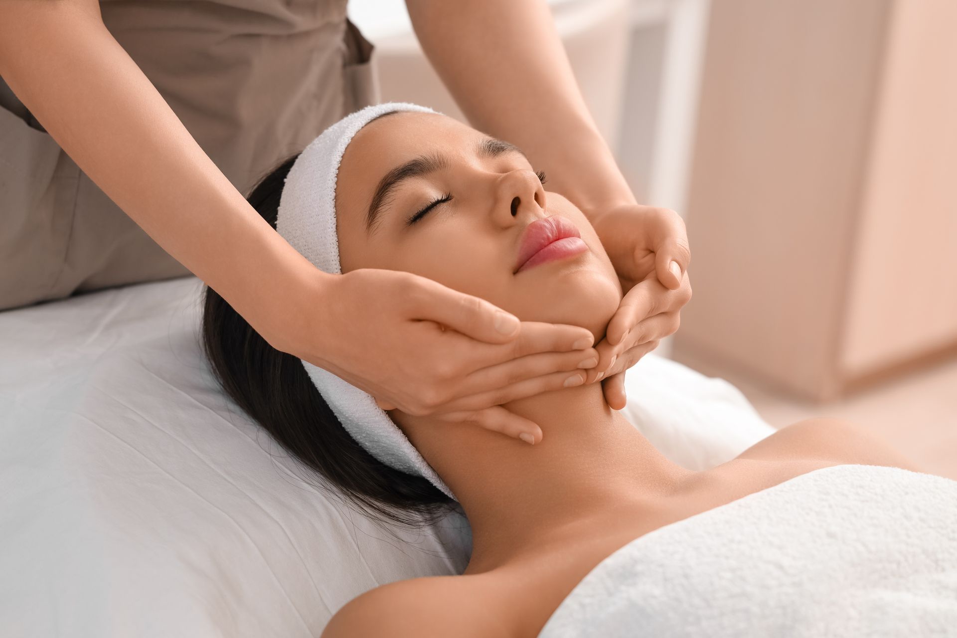 A woman is getting a facial treatment at a spa.