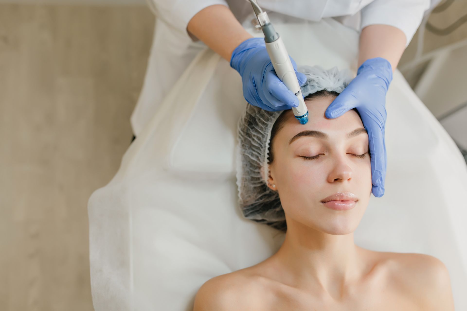 A woman is getting a facial treatment in a beauty salon.