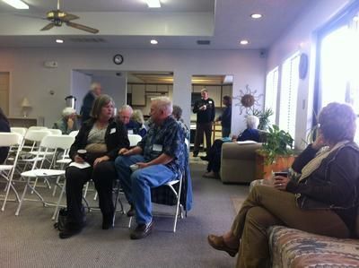 A group of people are sitting in chairs in a room
