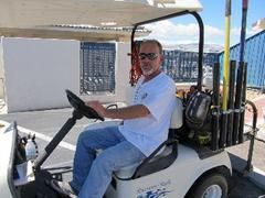 A man is sitting in a golf cart.