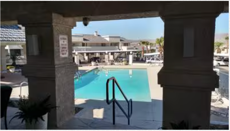 A large swimming pool with stairs leading to it