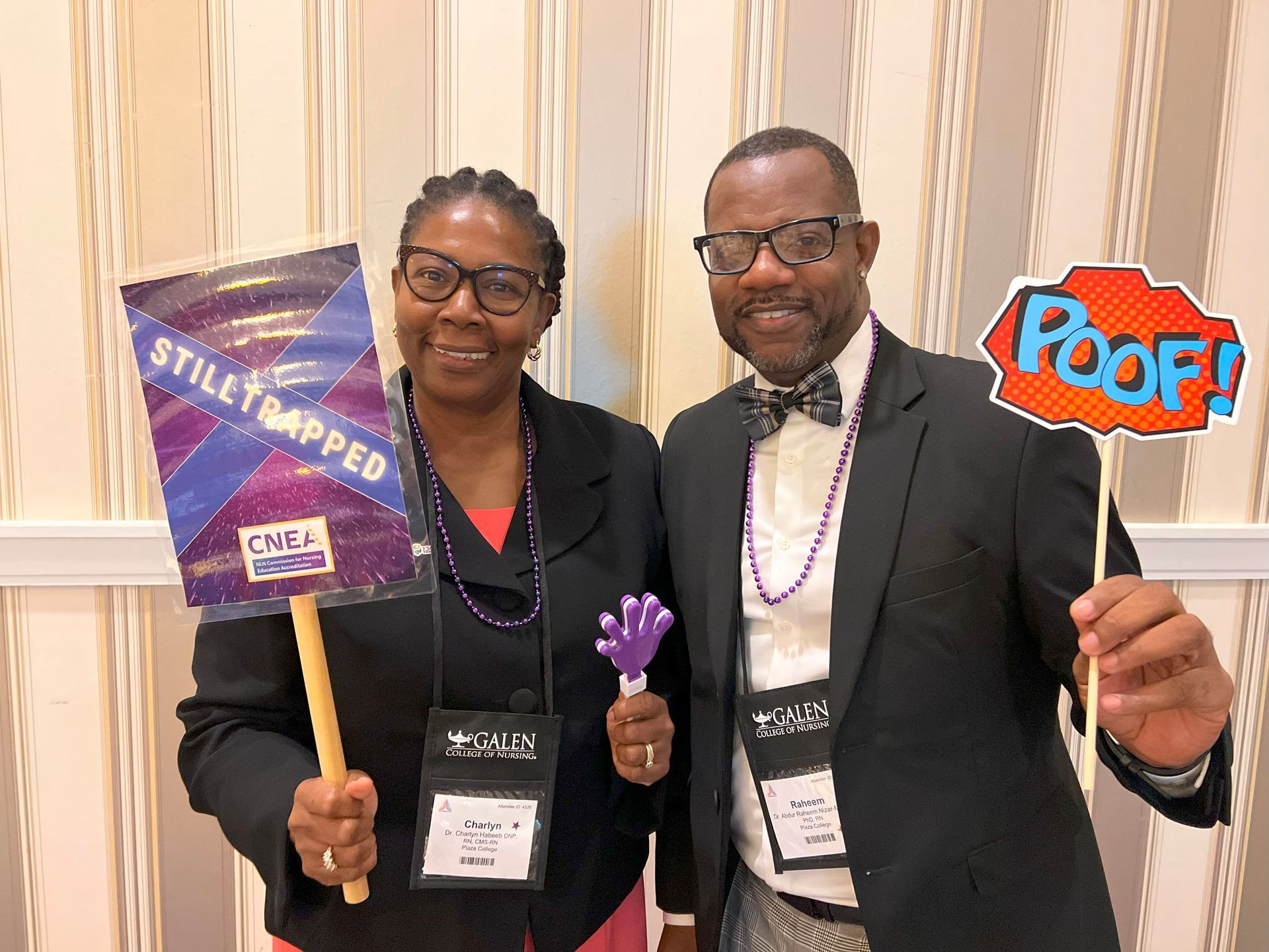 Two people holding signs and props