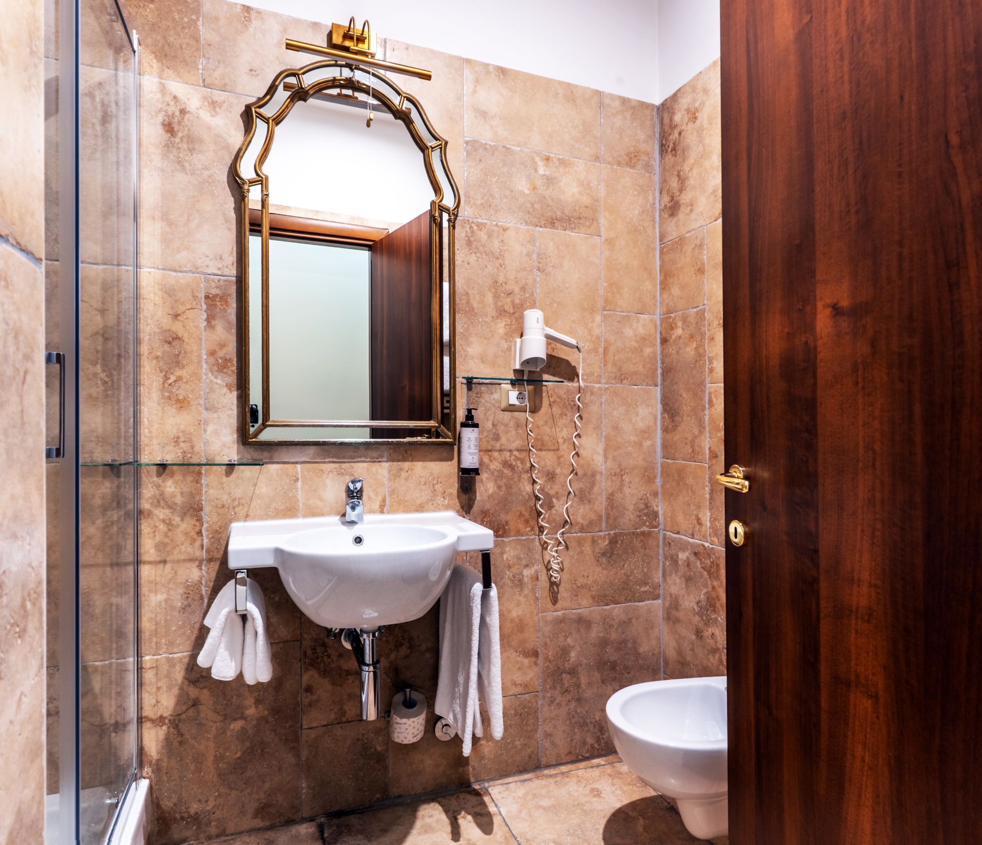 A bathroom with a sink , toilet and mirror.