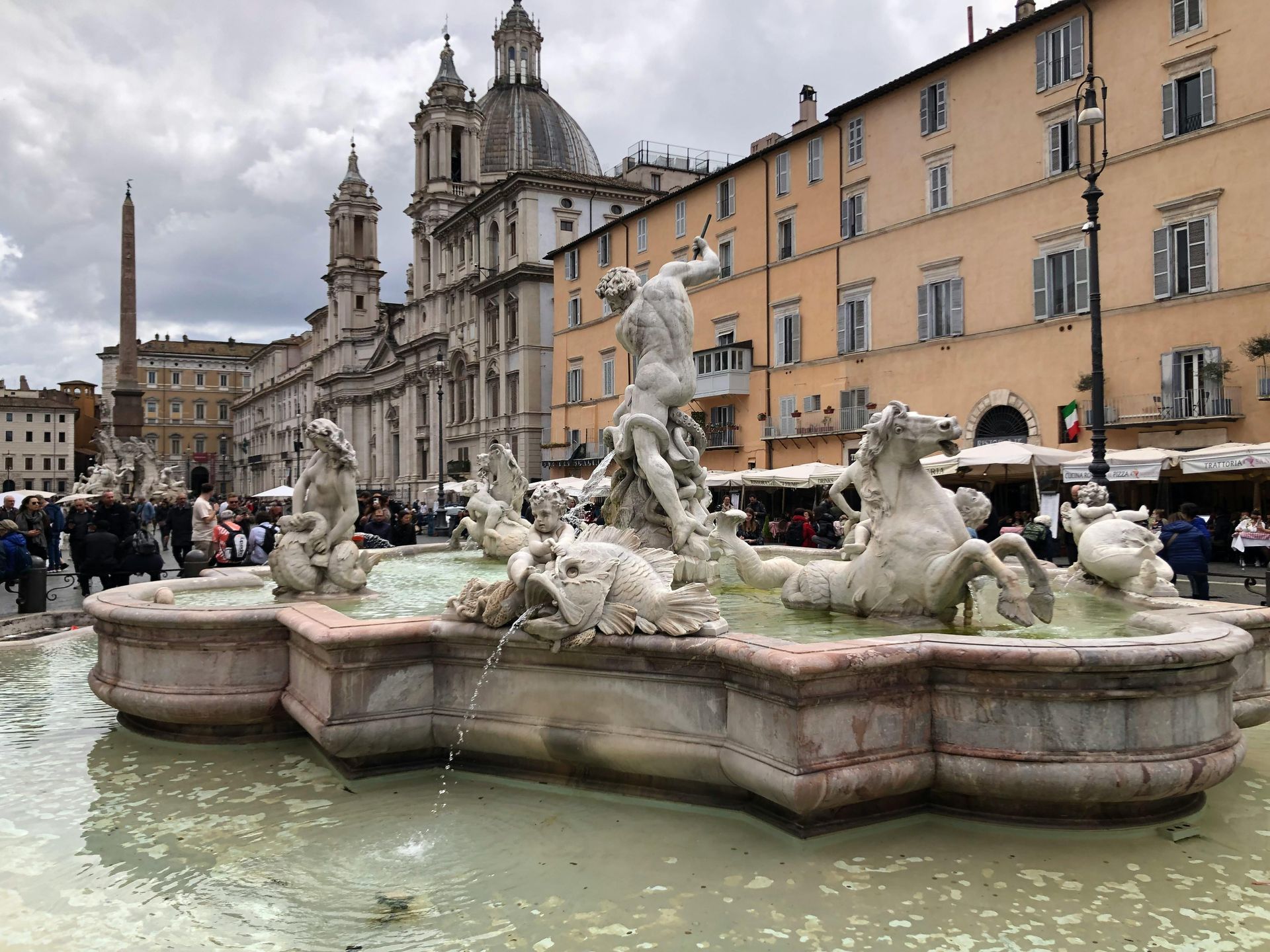A fountain in front of a building in a city