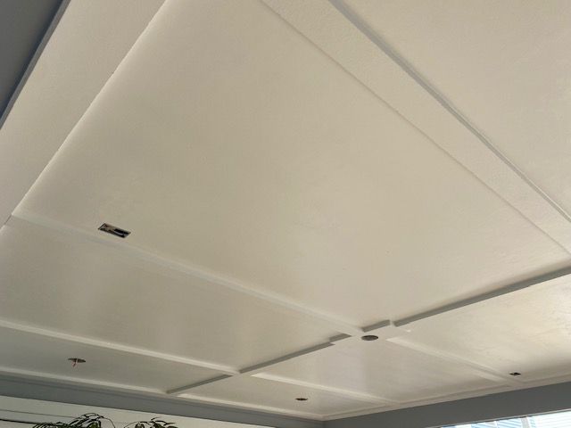 White tray ceiling with recessed lights in a modern room