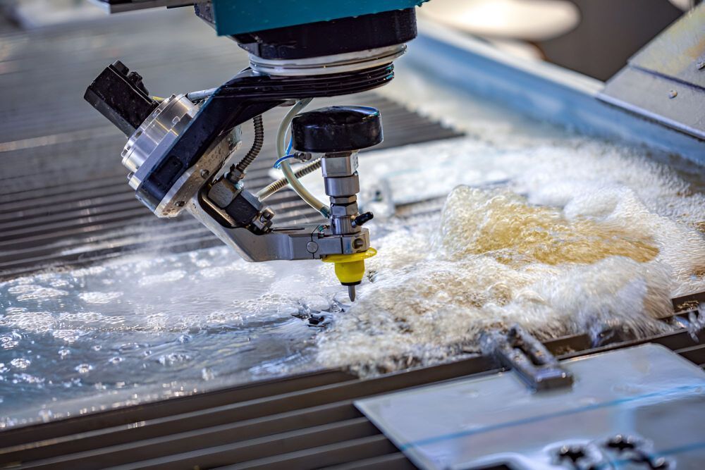 A Machine is Cutting a Piece of Metal With Water — NQBC Pty Ltd in Bowen, QLD