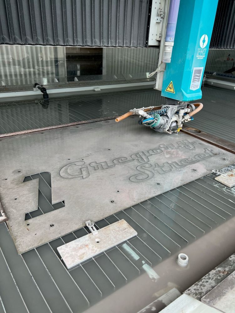 A Machine is Cutting a Piece of Metal With Water — NQBC Pty Ltd in Collinsville, QLD