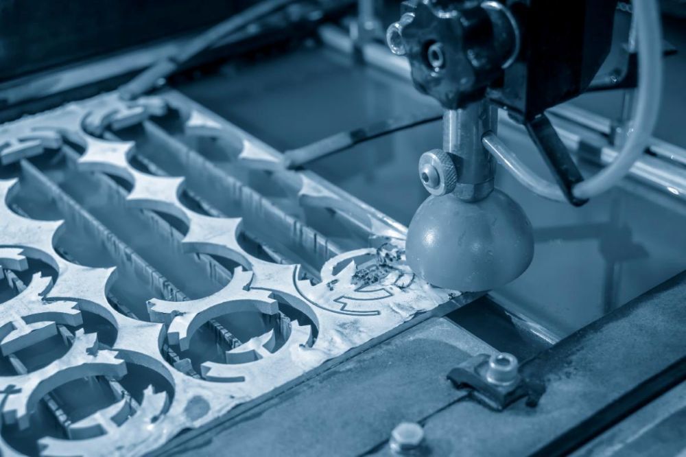 A Machine is Cutting a Piece of Metal With Water — NQBC Pty Ltd in Emerald, QLD