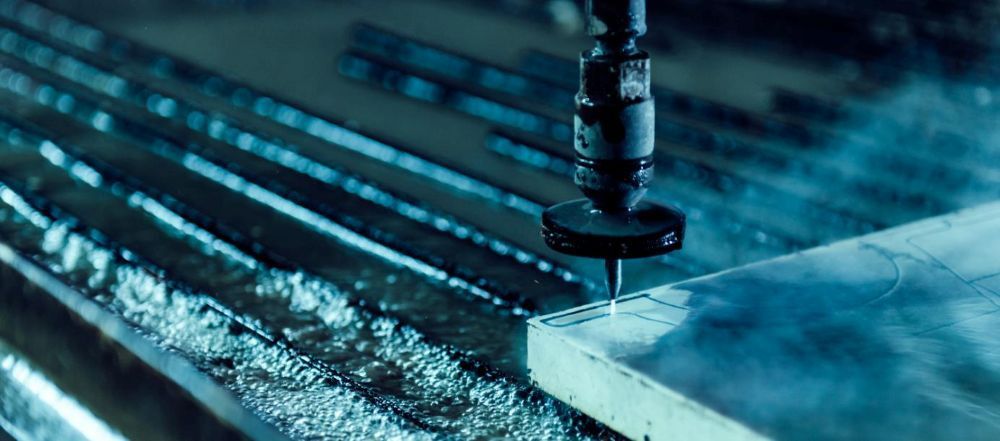 A Machine is Cutting a Piece of Metal With Water — NQBC Pty Ltd in Emerald, QLD