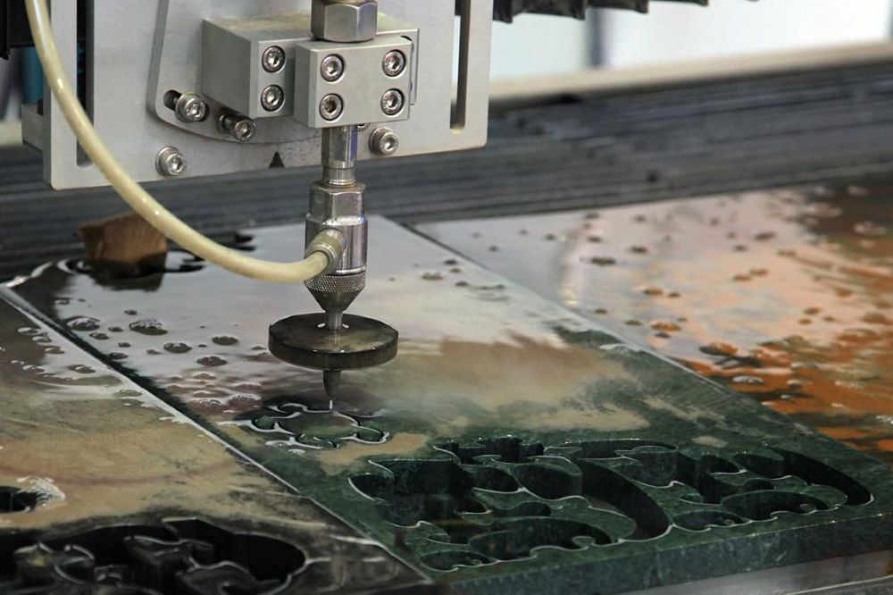 A Machine is Cutting a Piece of Metal With Water — NQBC Pty Ltd in Collinsville, QLD
