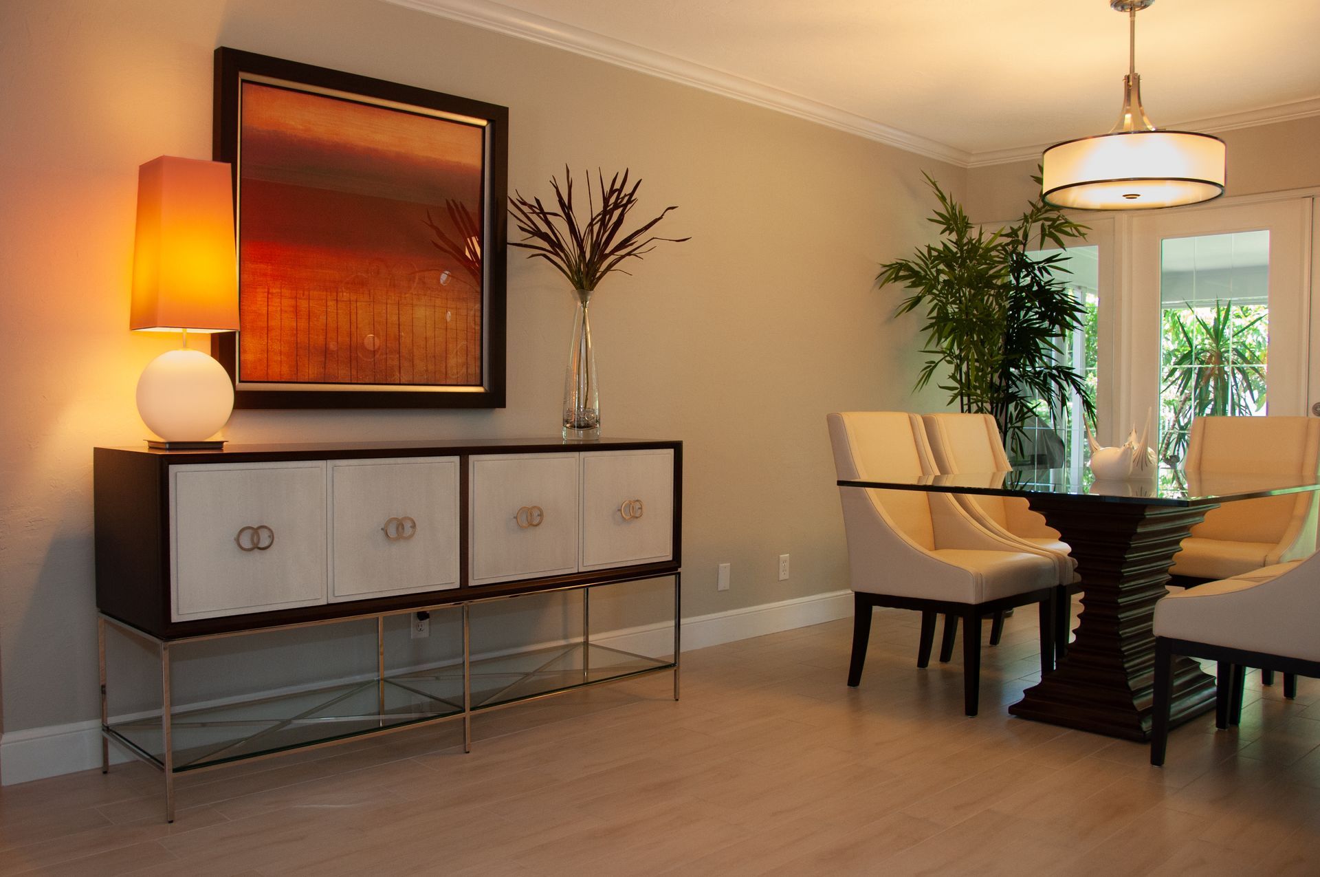 Bedroom with coral-colored walls, bed with pillows, two windows with blinds, nightstands, and a ceiling fan.