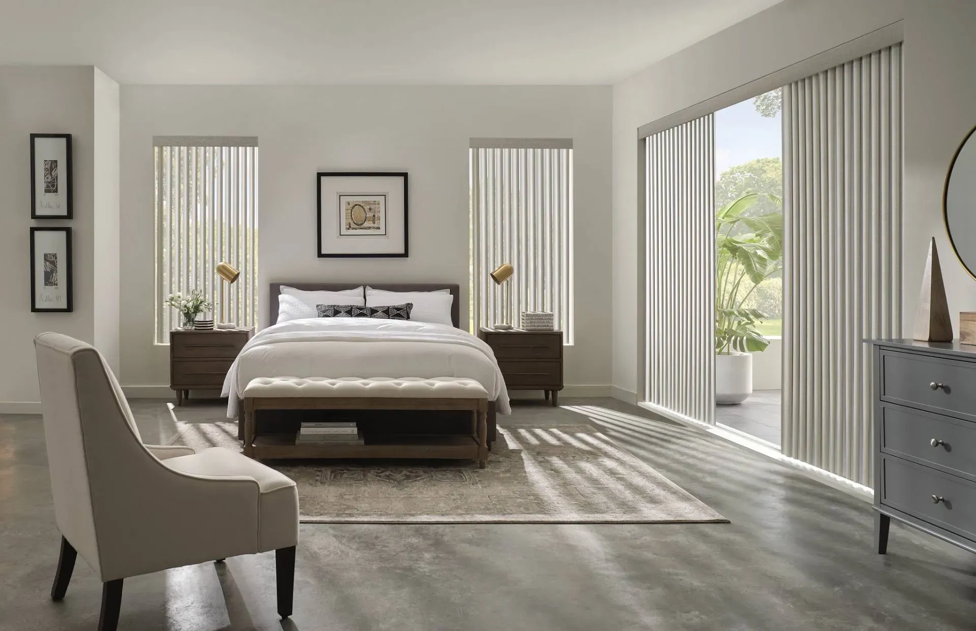 Bedroom with vertical blinds, bed, nightstands, chair, and dresser. Neutral tones, natural light.