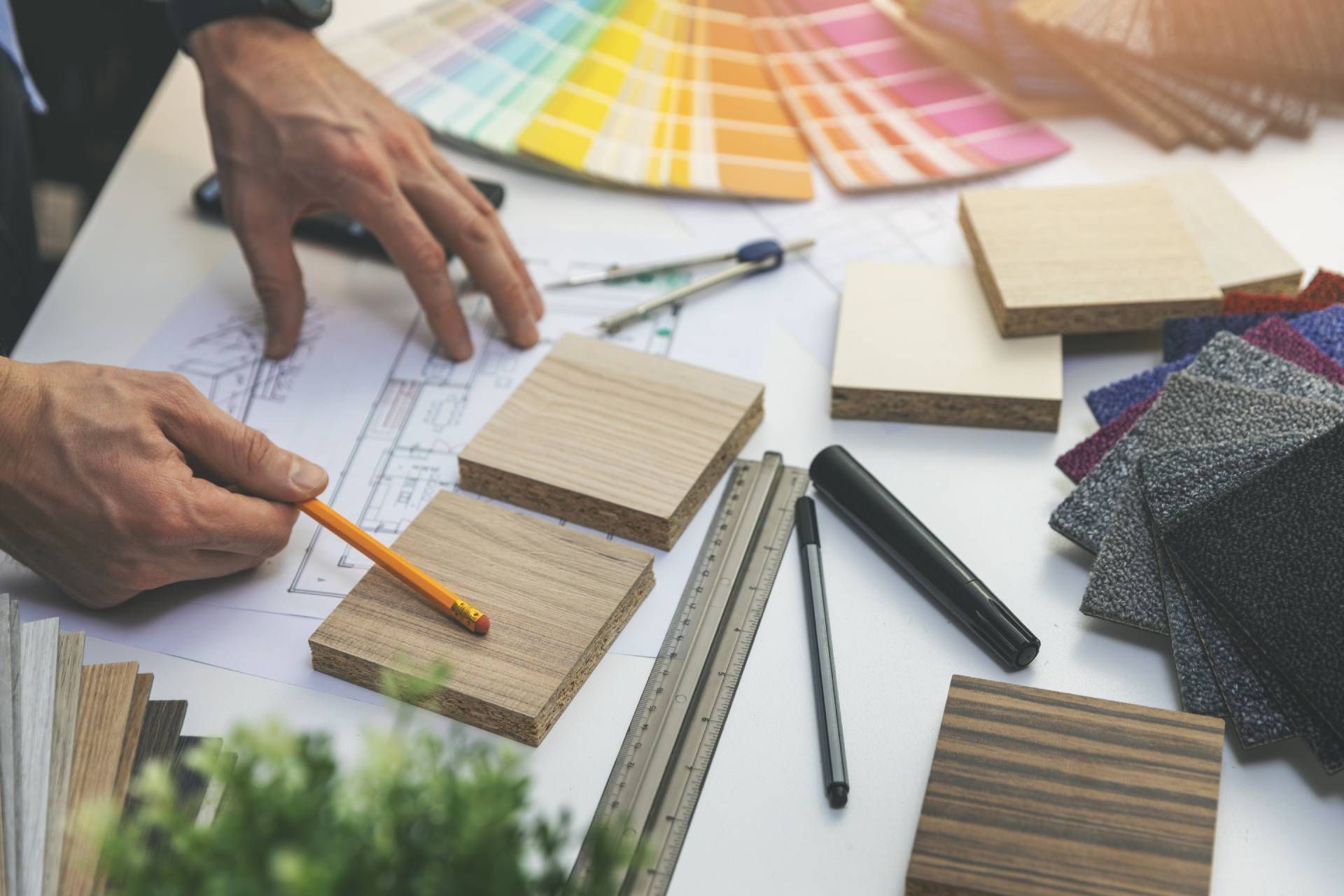 Interior designer looking over materials and color swatches on a table near North Fort Myers, FL