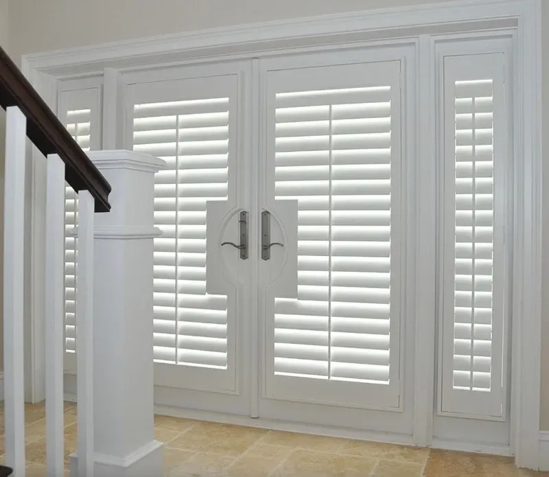 White shuttered doors and side panel, white column, light beige floor.
