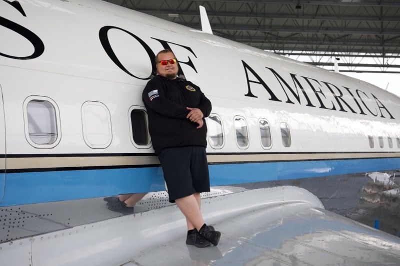 Man leaning against a plane with 