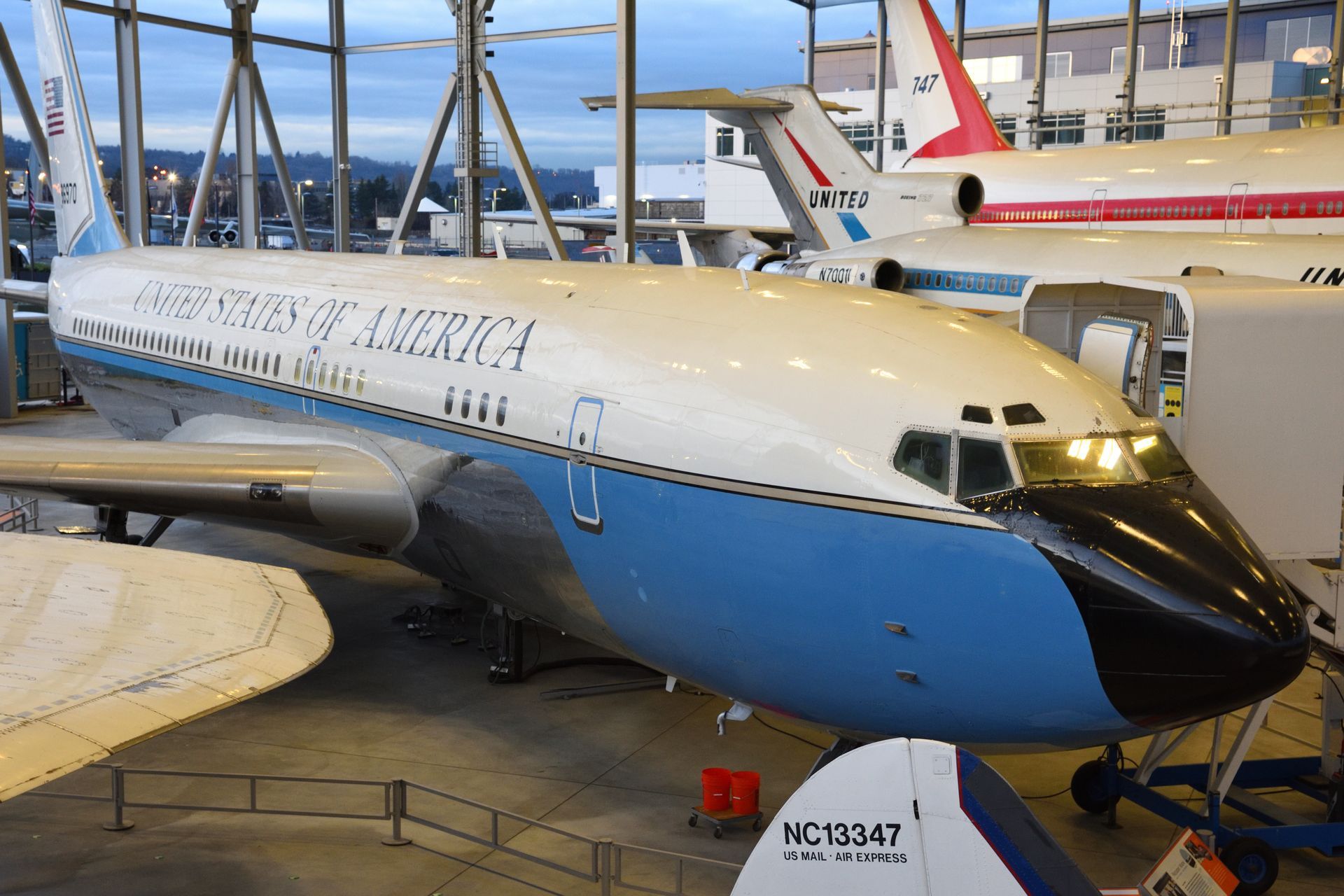 Former Air Force One plane on display at a museum. Blue and white livery. Black nose cone.