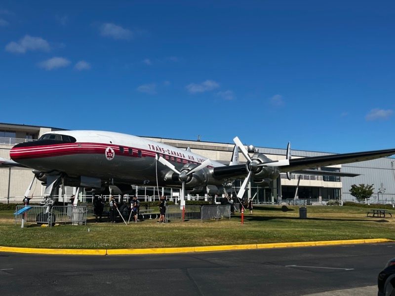 Vintage Trans World Airlines airplane on display outdoors. Red, silver, and white.
