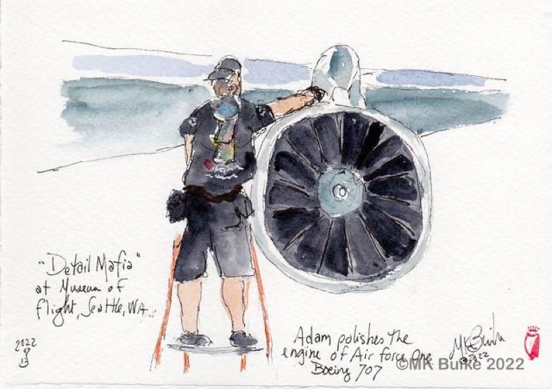 A man polishes a Boeing 707 engine at Seattle's Museum of Flight. He stands on a small platform.