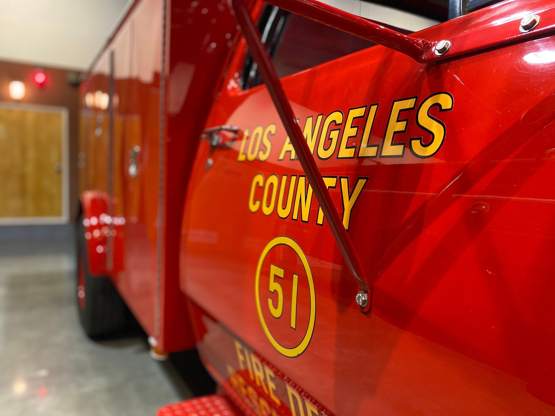 Red Los Angeles County Fire Dept. truck, door marked with
