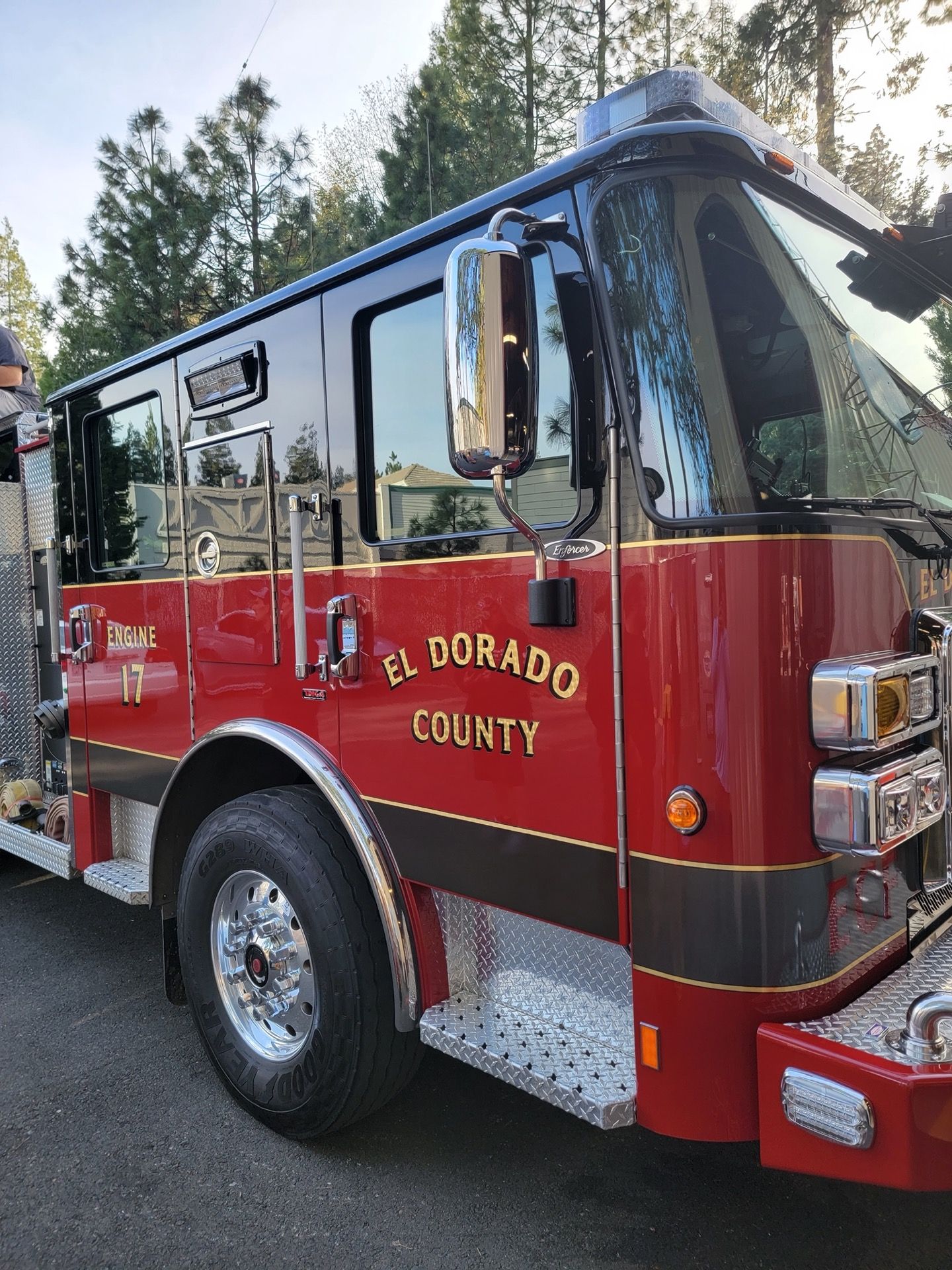 Fire engine from El Dorado County, red and black, parked outdoors.